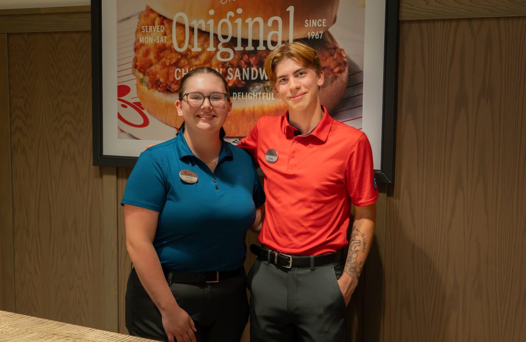 Cashlin Rogers, right, stands with his manager in Chick-fil-A.