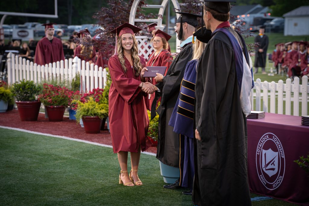 Student receives diploma.