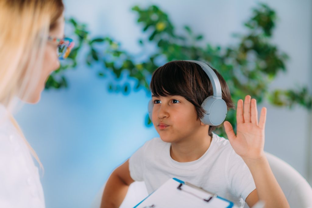 Hearing Test for Children. Early detecting hearing problems which can affect speech and language development. Audiologist Working with a Preschooler Boy
