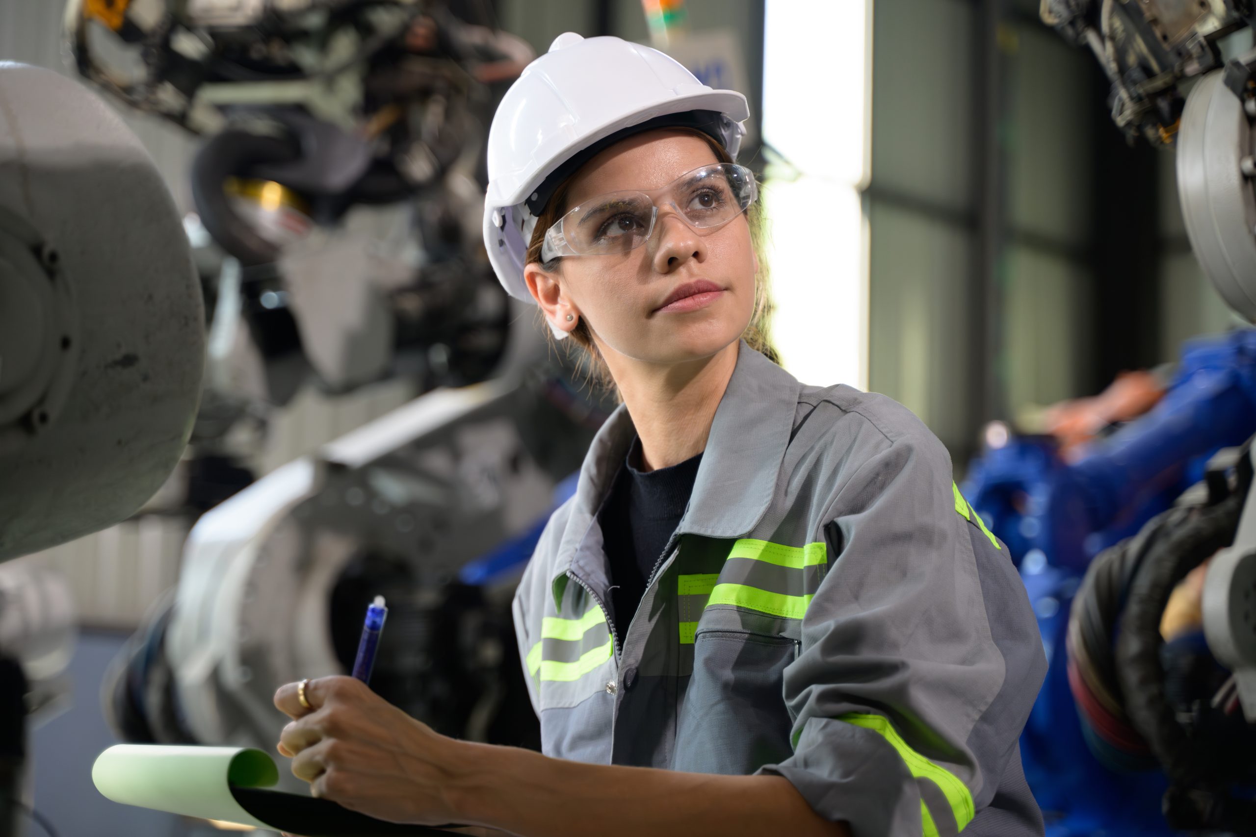 A female student in engineering inspects equipment.