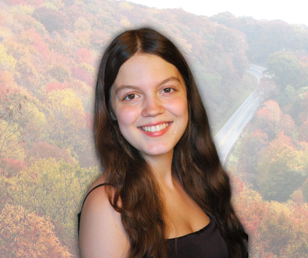 A headshot of Hannah Bastian against a transparent image of a mountain range in the fall. 